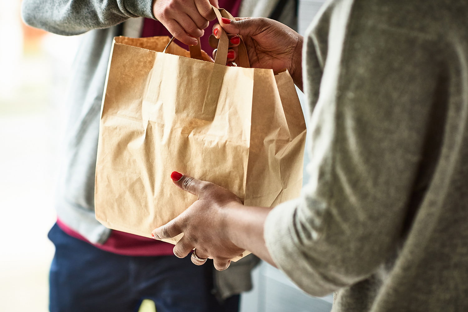 Close Up Of Woman Receiving Take Away Food Delivery